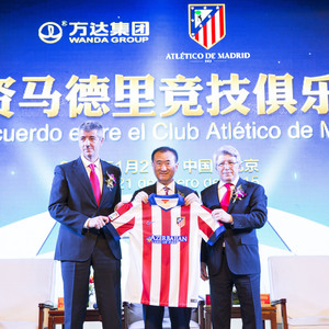 Miguel Angel Gil, Enrique Cerezo y Wang Jianlin posan con una camiseta del Atlético en Beijing