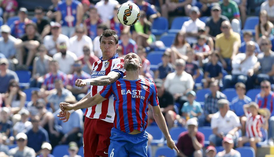 Temporada 14/15. Partido Levante - Atlético de Madrid. Mandzukic pelea con un rival para intentar llevarse de cabeza el esférico.